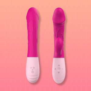 Two pink and white personal massagers shown upright against a peach-pink grid background.