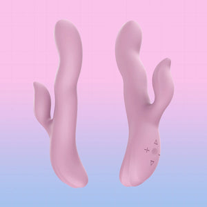 A pink, dual-ended, organic-shaped personal massager shown from two angles against a pastel pink and blue gradient background.