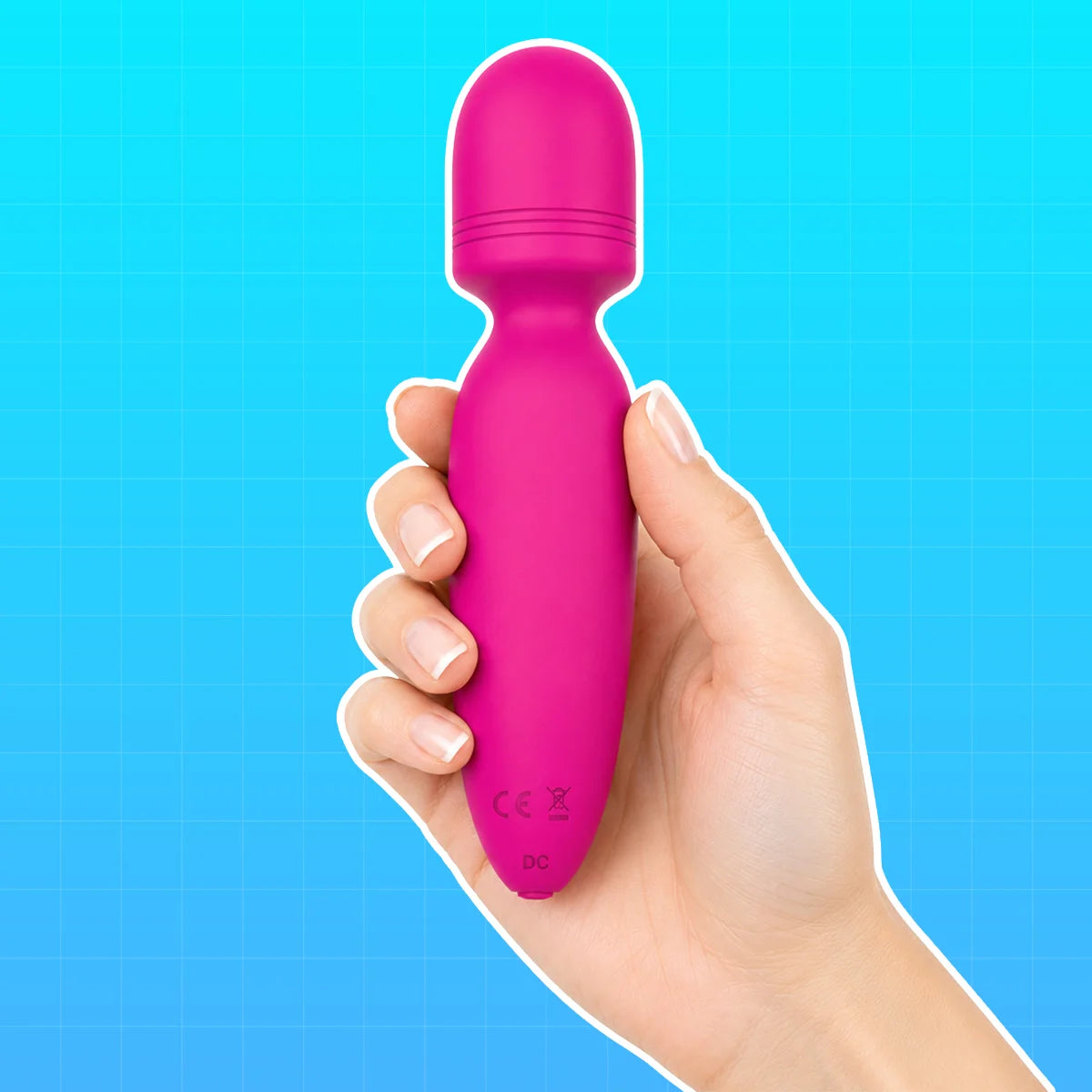 A hand holding a bright pink personal massager against a blue grid background.