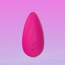 A pink teardrop-shaped personal massager with a matte finish and two control buttons on the front, set against a pink gradient background with a subtle grid pattern.